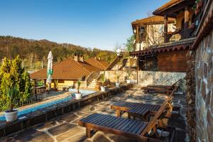 a patio with benches and a swimming pool at Safari Village Velingrad in Velingrad