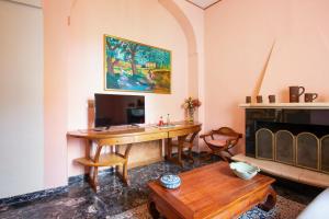 a room with a desk with a computer and a fireplace at 4 bedrooms apartement with furnished terrace and wifi at Cava de' Tirreni 3 km away from the beach in Cava deʼ Tirreni