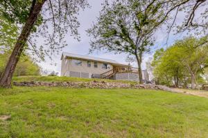 a house on a hill with a yard at Lake of the Ozarks Vacation Rental with Boat Dock! in Edwards