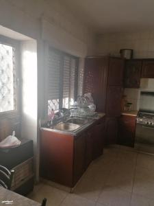 a small kitchen with a sink and a stove at Duraidi in Amman