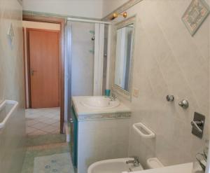 a bathroom with a sink and a toilet and a mirror at MARGIC in San Vito lo Capo