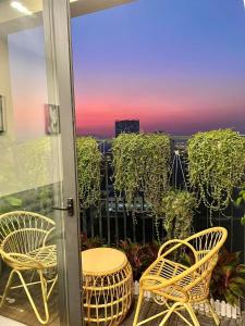 a balcony with chairs and a view of a city at Smart homestay in Hanoi