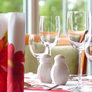 a table with three wine glasses on a table at Akzent Hotel Residence Bautzen in Bautzen