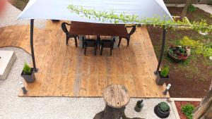 an overhead view of a table and chairs under an umbrella at Apartments & Studio Pekica in Rovinj