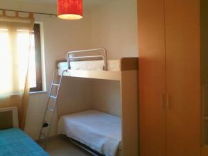 a room with two bunk beds and a ladder at SASSI E MARE in Policoro