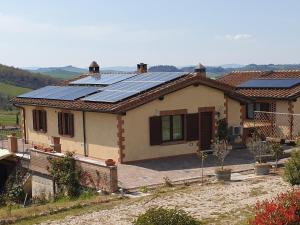 a house with solar panels on the roof at La Fornace in Rapolano Terme