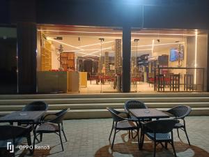 a group of tables and chairs in front of a window at Chalet at Lasirena Mini Egypt Resort Ein Elsokhna Families Only in Ain Sokhna