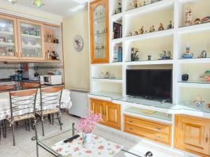 a living room with a tv and a dining room at Apartamento Florida EME in Sanxenxo