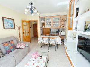 a living room with a couch and a table at Apartamento Florida EME in Sanxenxo