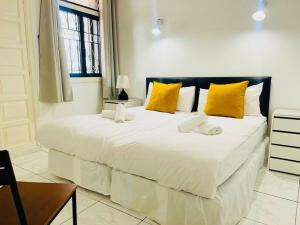 a bedroom with a large white bed with yellow pillows at Comfy home with large terrace five minutes from ocean in Los Cristianos +16 photos