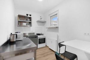 a small white kitchen with a table and a counter top at Apartment with balcony in Marl in Marl