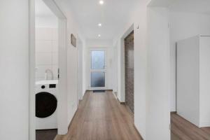 a white hallway with a sink and a washing machine at Apartment with balcony in Marl in Marl