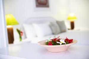 a bowl of flowers sitting on a table in a bedroom at Studio with shared pool furnished balcony and wifi at Lowlands in Lowlands