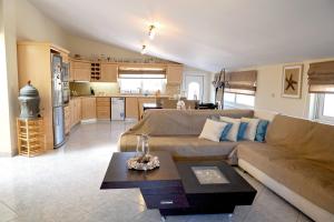a living room with a couch and a kitchen at Harmony Villa in Kalymnos