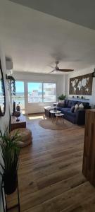 a living room with a couch and a table at Sunsetmare Vacational Apartment in Roses