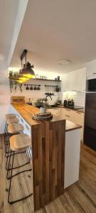a kitchen with a counter with stools in it at Sunsetmare Vacational Apartment in Roses
