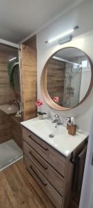 a bathroom with a sink and a mirror at Sunsetmare Vacational Apartment in Roses