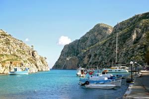 a group of boats docked at a dock in the water at Harmony Villa in Kalymnos