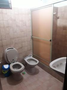 a bathroom with a toilet and a sink at D' Charrúas Hostel Concordia in Concordia +25 photos