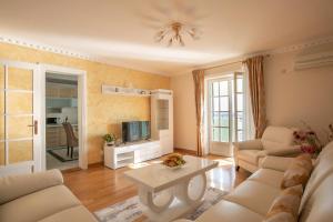 a living room with a couch and a table at Montesan Luxury Apartment in Sveti Stefan