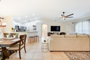 a living room and kitchen with a couch and a table at Pet-Friendly Naples Vacation Rental with Fire Pit! in Naples