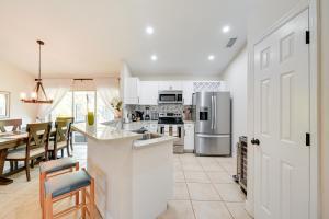 a kitchen with white appliances and a table with chairs at Pet-Friendly Naples Vacation Rental with Fire Pit! in Naples