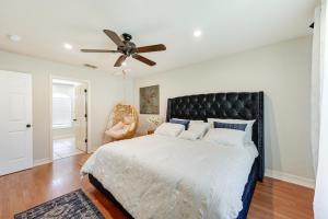 a bedroom with a large bed with a ceiling fan at Pet-Friendly Naples Vacation Rental with Fire Pit! in Naples