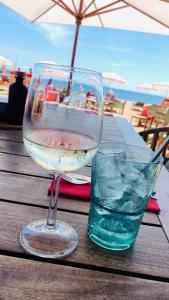 a glass of wine and a glass of water on a table at Logement avec deux velos in Hyères