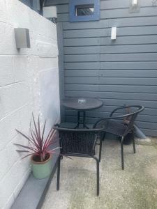 a table and two chairs and a table and a plant at Boutique apartment in Wicklow