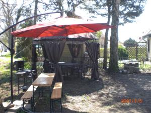 a gazebo with a table and chairs under it at mecklenburgerseenplatt 2 in Teschendorf