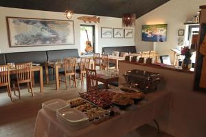 a restaurant with a buffet of food on a table at Denmark Outdoor Lodge in Ebberup +36 photos