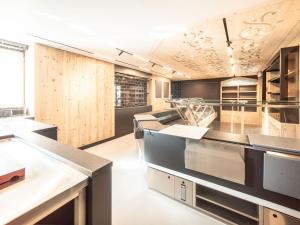 a large kitchen with wooden walls and counters at Dorfplatz Urnäsch in Urnäsch