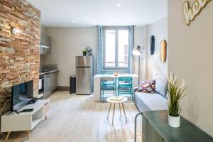 Le NewYorkais - Appartement 4 pers- Oullins-Lyon في أولينز: غرفة معيشة مع أريكة ومطبخ