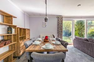 a dining room with a table and chairs at Church Close in Coltishall