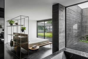 a bedroom with a bed and a glass wall at Casa dos Sobreiros by LovelyStay in Celorico de Basto