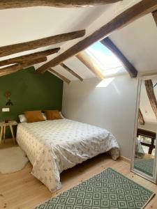 a bedroom with a bed and a green wall at EL VIEJO MOLINO in Lugo