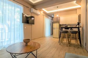 a kitchen with a table and some chairs in a room at Ventiri Suite 2 in Athens