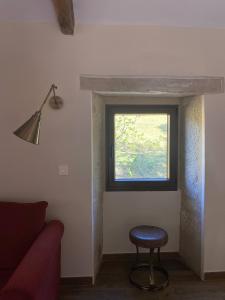 a room with a stool and a window at EL VIEJO MOLINO in Lugo