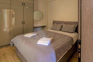 a bedroom with a bed with towels on it at Ventiri Suite 2 in Athens