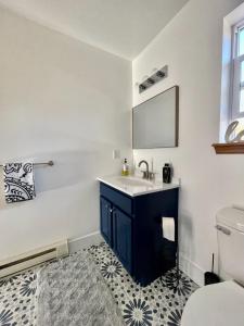 a bathroom with a sink and a toilet at Modern Poconos home, game room, pool, waterparks in Albrightsville
