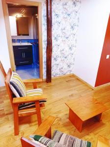 a living room with a chair and a table at Casa das Pozas 2 in Monforte de Lemos