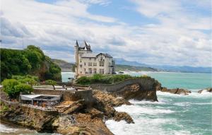 a castle on a cliff next to the ocean at Gorgeous Apartment In Saint-pe-sur-nivelle With House A Panoramic View in Saint-Pée-sur-Nivelle