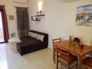 a living room with a couch and a table at Mat Old Town Apartments L in Rethymno