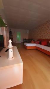 a large room with two beds and a table at Fantástico apartamento con piscina en Tossa de Mar in Tossa de Mar