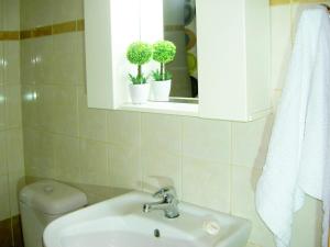 a bathroom with a sink and a toilet and a window at Mat Old Town Apartments L in Rethymno +25 photos