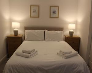 a bedroom with a bed with towels on it at Rossett Pike in Bowness-on-Windermere