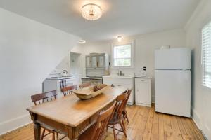 a kitchen with a wooden table and a white refrigerator at Quiet Farmhouse on 77 Acres Near Shenandoah River! in Elkton