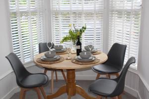 a dining room with a wooden table and chairs at Rossett Pike in Bowness-on-Windermere +13 photos
