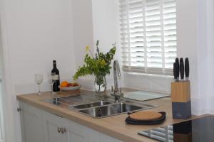 a kitchen with a sink and a bottle of wine at Rossett Pike in Bowness-on-Windermere