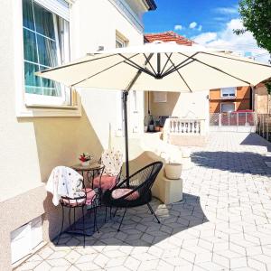 a table and chairs under an umbrella on a patio at 4-teen in Jagodina